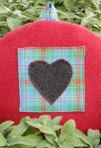 upcycled red sweater felt tea cozy with heart on sage background